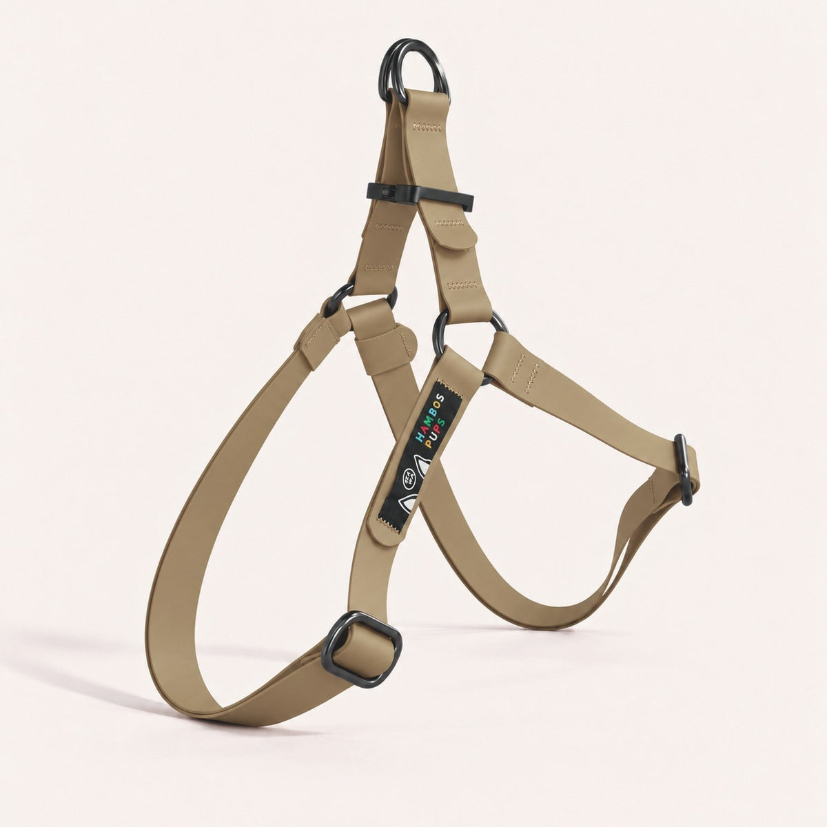 PNW Dry Harness in Toast Biothane with black hardware and the Hambos Pups label, studio shot