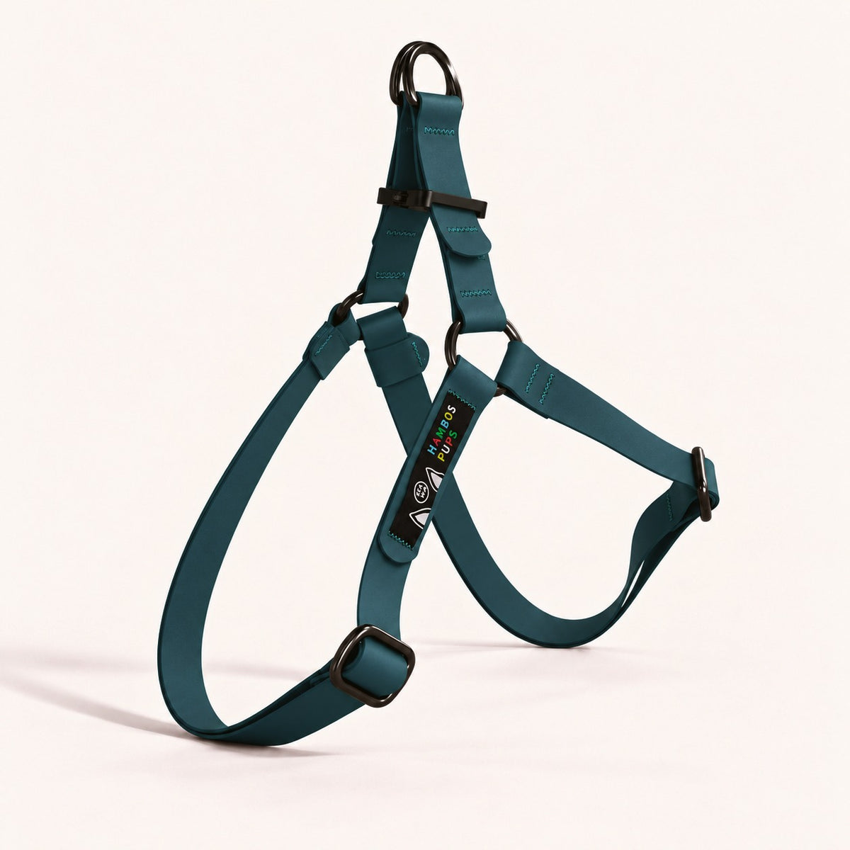 PNW Dry Harness in Water Moss Biothane with black hardware and the Hambos Pups label, studio shot